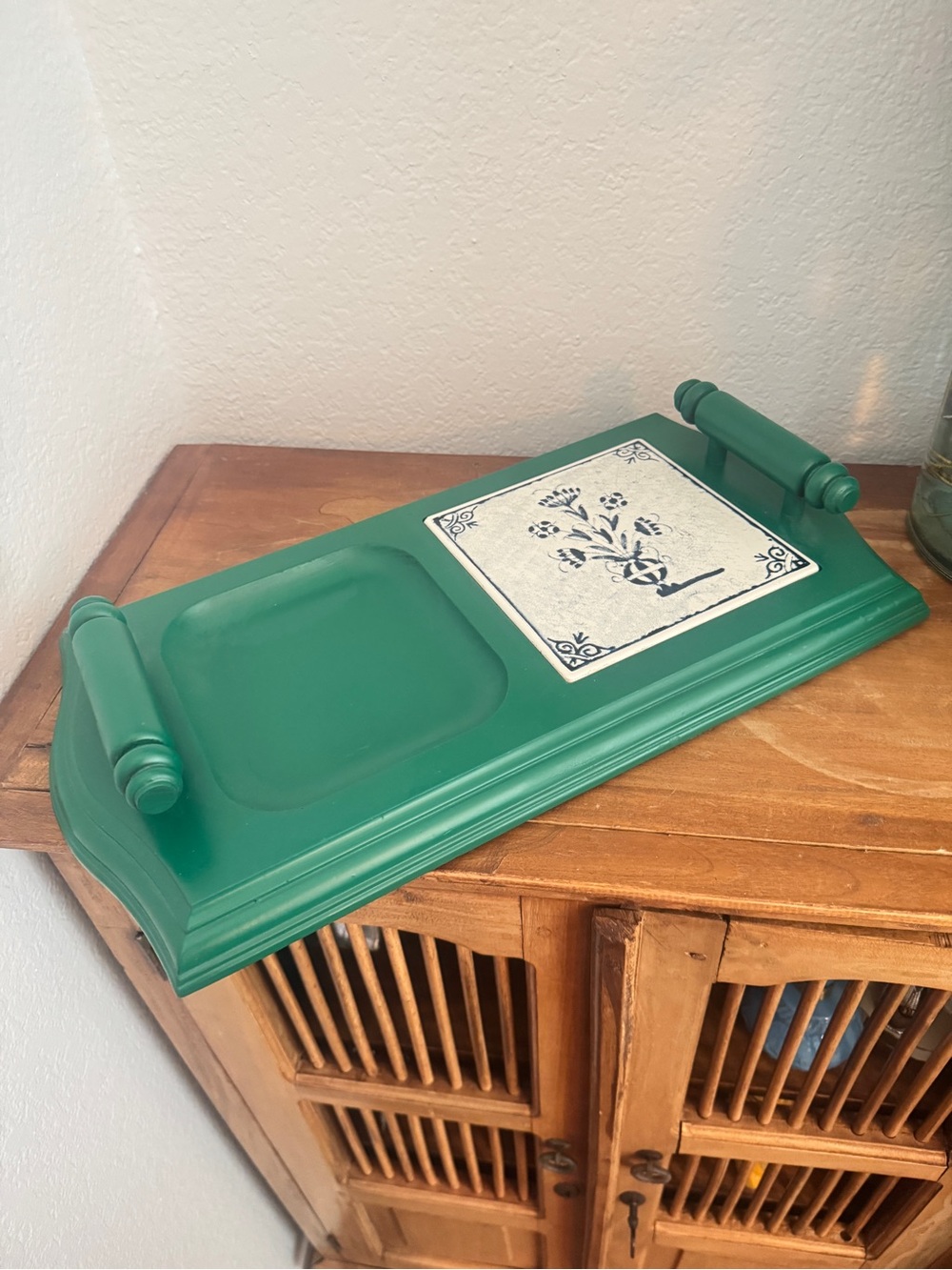 vintage painted wooden tray featuring a distinctive inset metal accent print